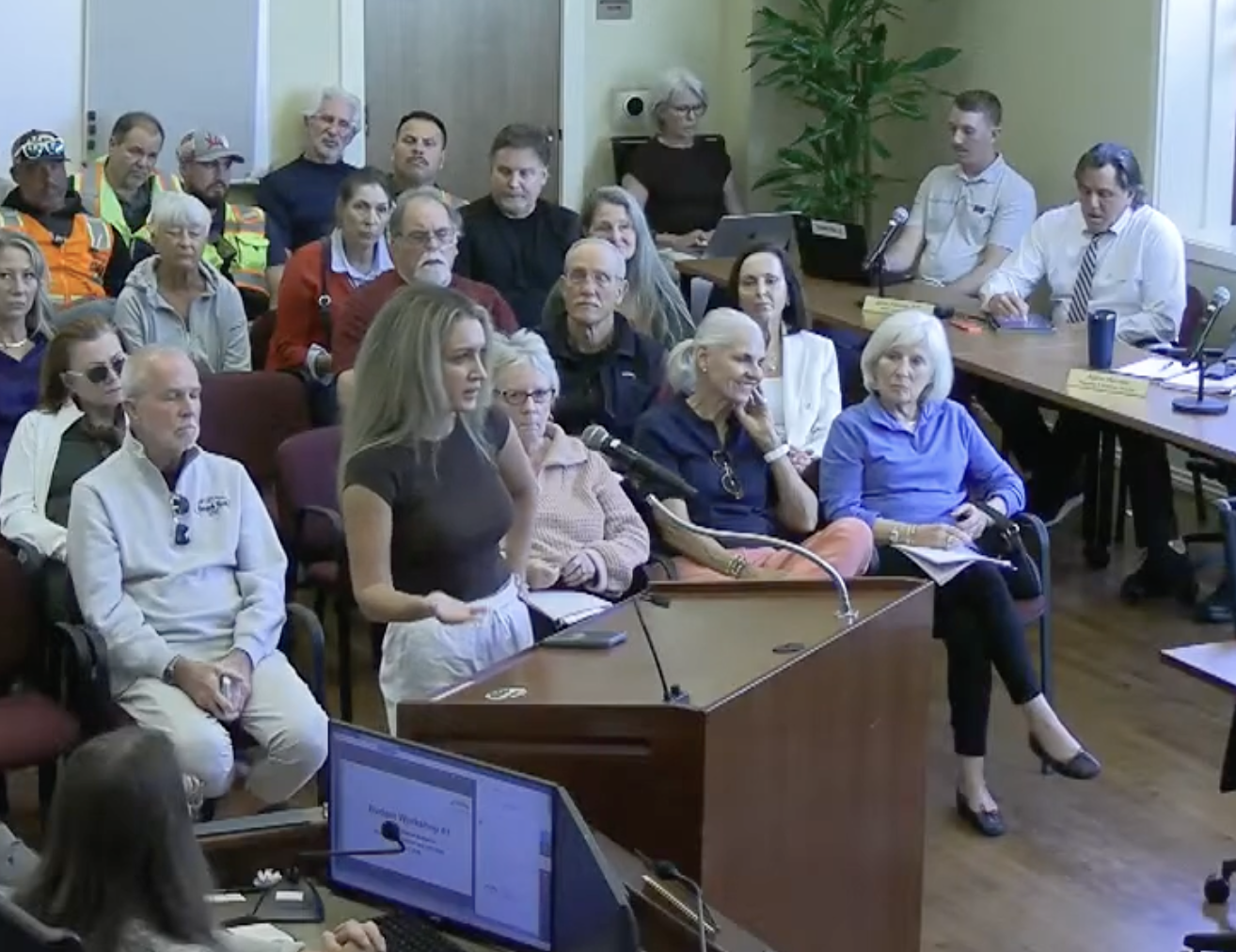 Jessi Bugden speaking at a podium during a Yountville Town Council meeting, addressing council members and residents.